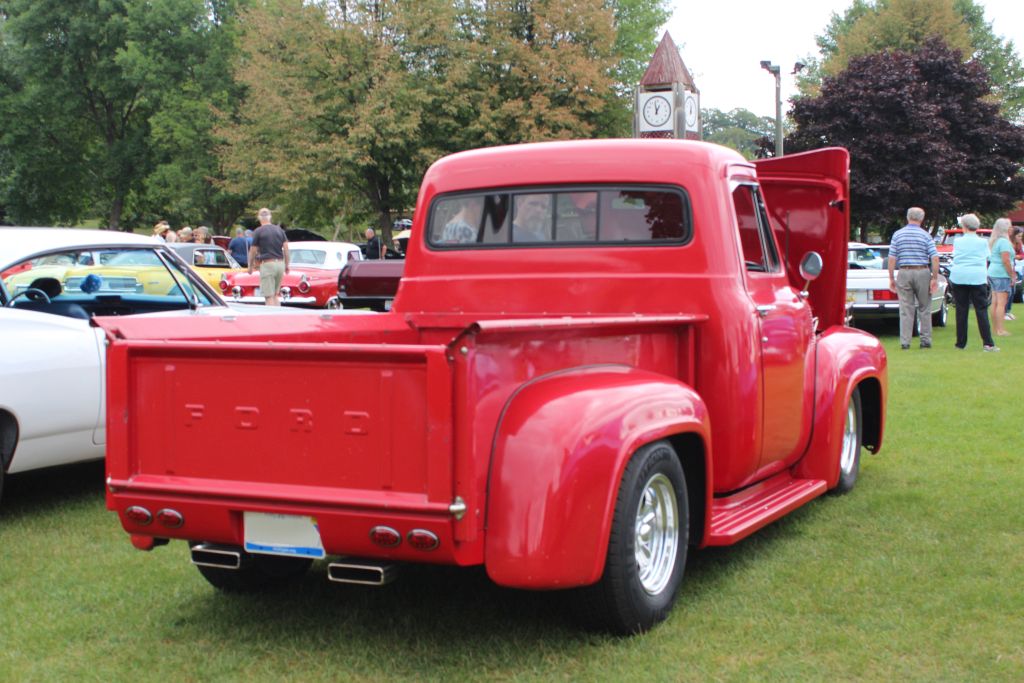 The Rear Side Of A Classic Ford Truck Painted In Bright Red