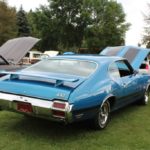 Rear shot of the bright blue Oldsmobile