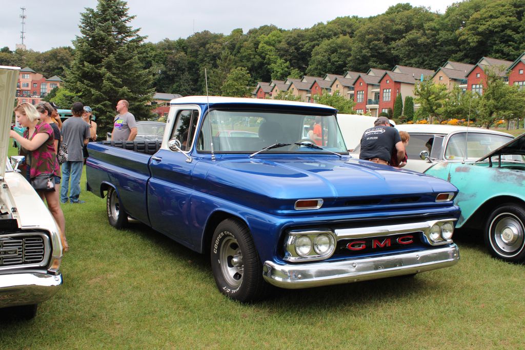 A Classic Ford Truck With Bright Blue Paint And A White Hood