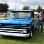 Owner poses with his beautiful blue Chevrolet Truck